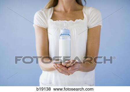 Stock Photo - woman holding a bottle.. Fotosearch