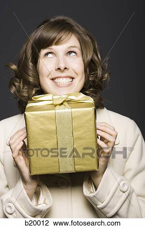 woman holding a gift View Large Photo Image Stock Image - woman holding a gift. Fotosearch