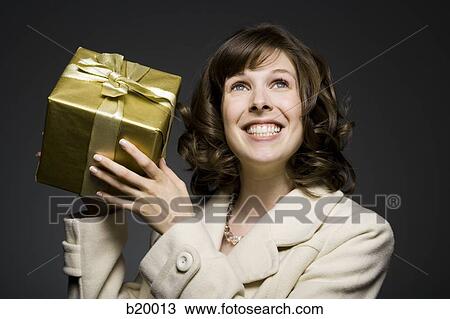woman holding a gift View Large Photo Image Stock Image - woman holding a gift. Fotosearch