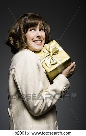 woman holding a gift View Large Photo Image Stock Photography - woman holding a gift. Fotosearch