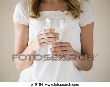 woman holding a glass of milk. View Large Photo Image Picture - woman holding a glass of milk.. Fotosearch