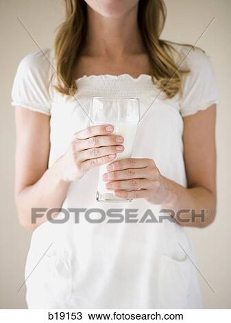 woman holding a glass of milk. View Large Photo Image Stock Image - woman holding a glass of milk.. Fotosearch