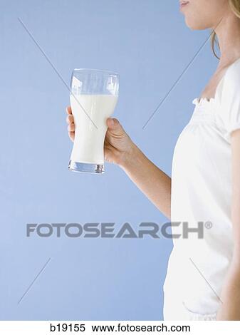 woman holding a glass of milk. View Large Photo Image Stock Photography - woman holding a glass of milk.. Fotosearch