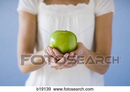woman holding a green apple. View Large Photo Image Stock Photo - woman holding a green apple.. Fotosearch