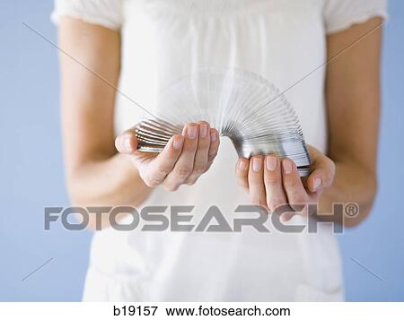 woman holding a springy toy. View Large Photo Image Stock Photo - woman holding a springy toy.. Fotosearch