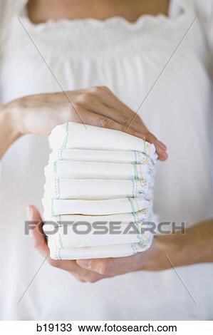 Woman holding a stack of diapers. View Large Photo Image Stock Image - Woman holding a stack of diapers.. Fotosearch