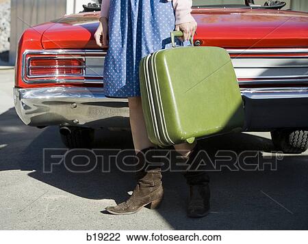 woman holding a suitcase View Large Photo Image Stock Image - woman holding a suitcase. Fotosearch
