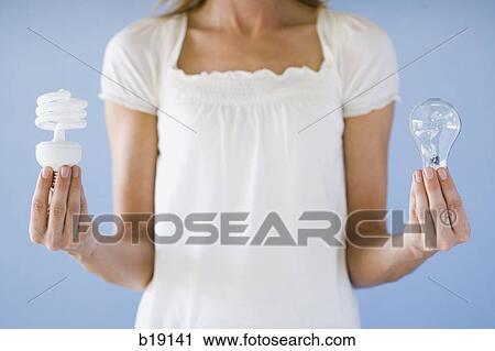 woman holding light bulbs. View Large Photo Image Stock Image - woman holding light bulbs.. Fotosearch