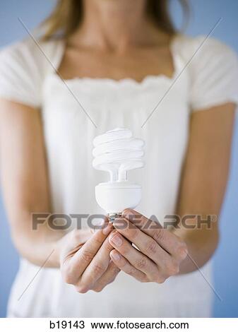 woman holding light bulbs. View Large Photo Image Stock Image - woman holding light bulbs.. Fotosearch