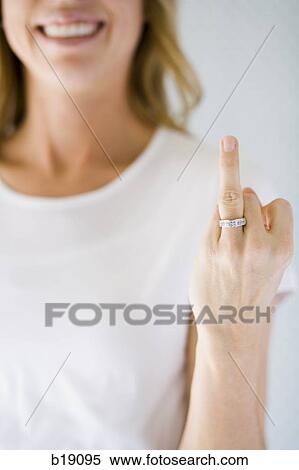 Stock Photography - Woman holding up her wedding ring.. Fotosearch
