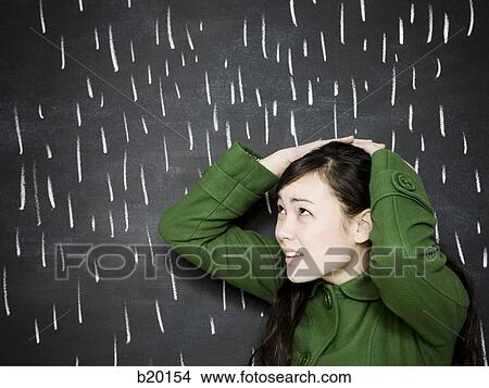 Picture - woman in a chalkboard rainstorm. Fotosearch