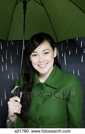 Stock Image - woman in a chalkboard rainstorm. Fotosearch