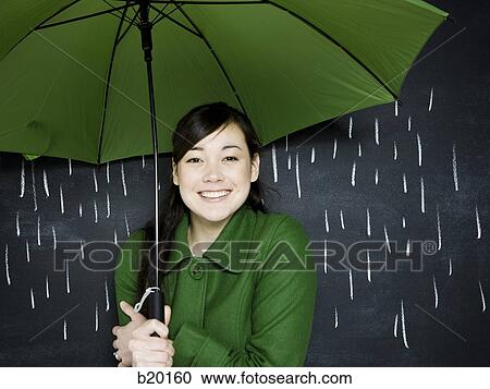 Stock Image - woman in a chalkboard rainstorm. Fotosearch