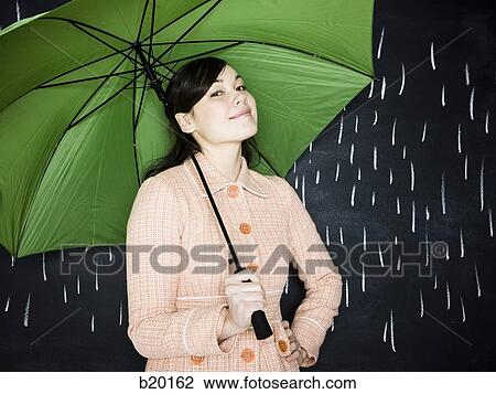 Stock Image - woman in a chalkboard rainstorm. Fotosearch