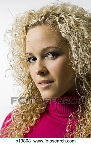 Stock Photo - woman in a pink sweater. Fotosearch