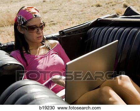 woman in a red convertible View Large Photo Image Stock Image - woman in a red convertible. Fotosearch