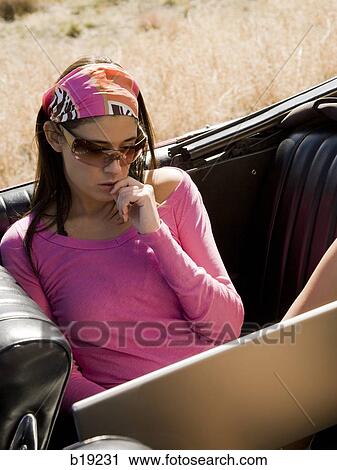 woman in a red convertible View Large Photo Image Stock Image - woman in a red convertible. Fotosearch