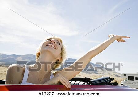 woman in a red convertible View Large Photo Image Stock Photo - woman in a red convertible. Fotosearch