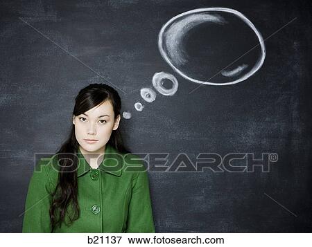 Stock Photo - woman in front of a chalkboard. Fotosearch