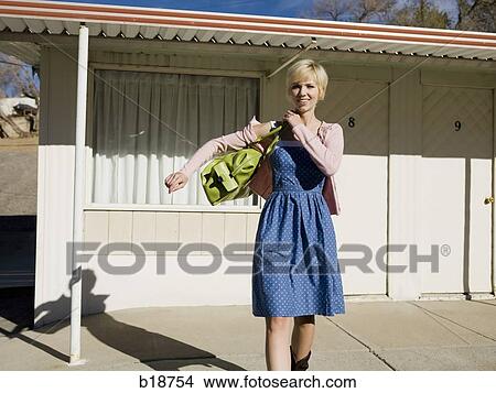 woman in front of a motel room. View Large Photo Image Picture - woman in front of a motel room.. Fotosearch