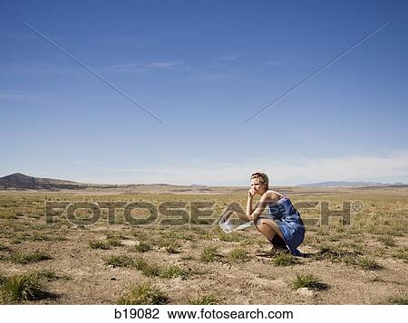 Stock Image - woman in the middle of nowhere.. Fotosearch