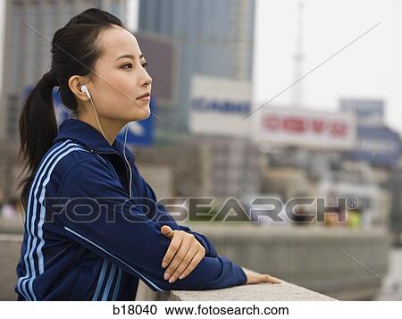 Woman listening to mp3 player. View Large Photo Image Stock Image - Woman listening to mp3 player.. Fotosearch