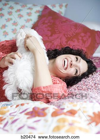 woman lying on a bed View Large Photo Image Picture - woman lying on a bed. Fotosearch