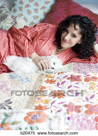 woman lying on a bed View Large Photo Image Stock Photography - woman lying on a bed. Fotosearch