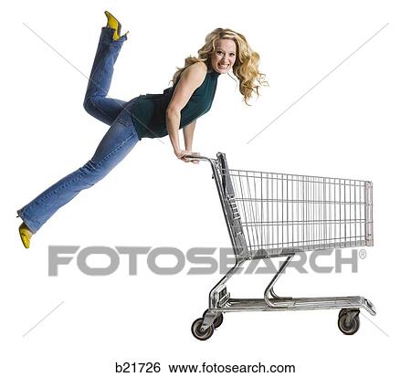 Stock Photograph - woman pushing a shopping cart. Fotosearch
