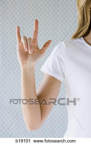 Stock Image - "Woman signing ""I love you"". ". Fotosearch