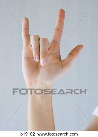 Stock Image - "Woman signing ""I love you"". ". Fotosearch