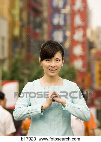 Woman standing on a busy city street bowing. View Large Photo Image Stock Image - Woman standing on a busy city street bowing.. Fotosearch