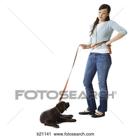 Stock Image - woman walking dog. Fotosearch