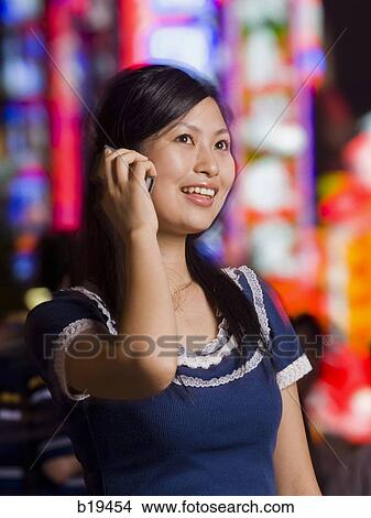 Picture - woman with a cell phone. Fotosearch