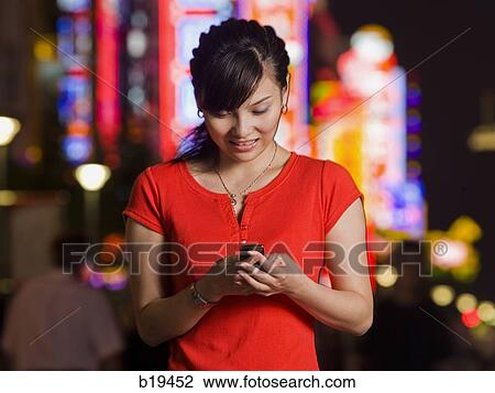 Stock Image - woman with a cell phone. Fotosearch