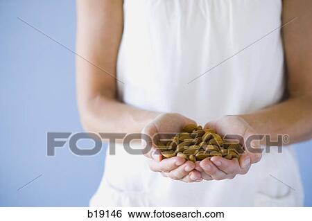 woman with a handfull of almonds. View Large Photo Image Stock Photograph - woman with a handfull of almonds.. Fotosearch