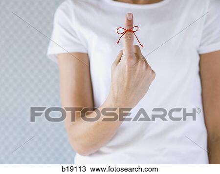 Woman with a red string tied on her finger. View Large Photo Image Stock Image - Woman with a red string tied on her finger.. Fotosearch