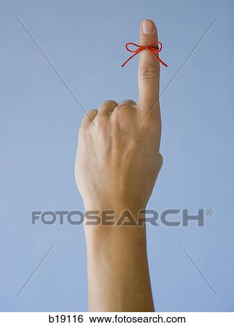 Woman with a red string tied on her finger. View Large Photo Image Stock Photograph - Woman with a red string tied on her finger.. Fotosearch
