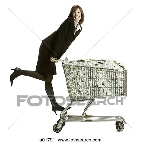 Stock Image - woman with a shopping cart full of money. Fotosearch