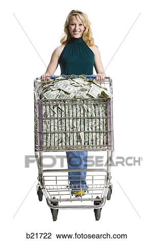 woman with a shopping cart full of money View Large Photo Image Stock Image - woman with a shopping cart full of money. Fotosearch