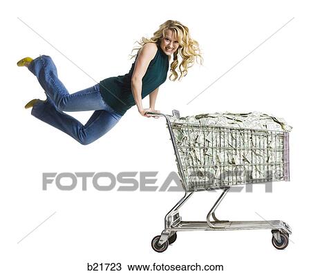 woman with a shopping cart full of money View Large Photo Image Stock Image - woman with a shopping cart full of money. Fotosearch