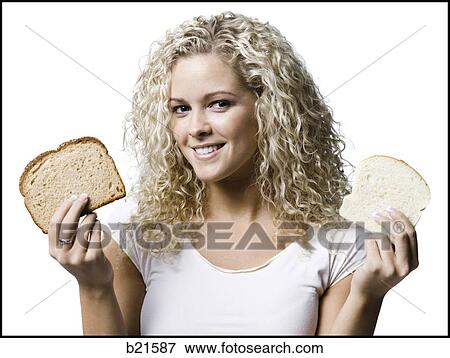 woman with a slice of white and wheat bread View Large Photo Image Stock Photo - woman with a slice of white and wheat bread. Fotosearch