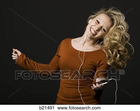 Stock Image - woman with an mp3 player. Fotosearch