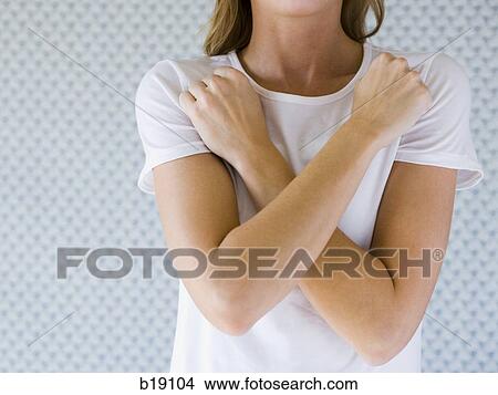 Woman with arms crossed against chest. View Large Photo Image Picture - Woman with arms crossed against chest.. Fotosearch