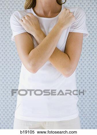 Woman with arms crossed against chest. View Large Photo Image Stock Photography - Woman with arms crossed against chest.. Fotosearch