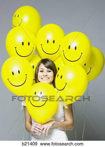 woman with smiley face balloons View Large Photo Image Stock Photo - woman with smiley face balloons. Fotosearch