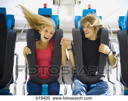 Stock Image - young couple at an amusement park. Fotosearch