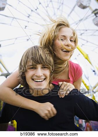 Stock Photograph - young couple at an amusement park. Fotosearch