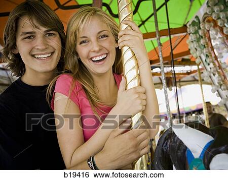 Stock Photograph - young couple at an amusement park. Fotosearch