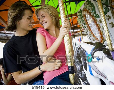 Stock Photography - young couple at an amusement park. Fotosearch